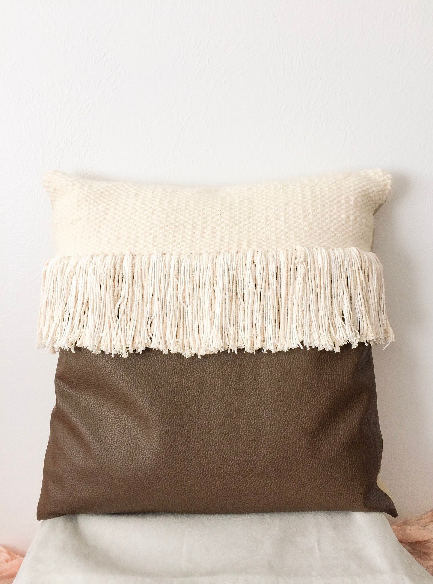Brown leather and fringe woven pillow
